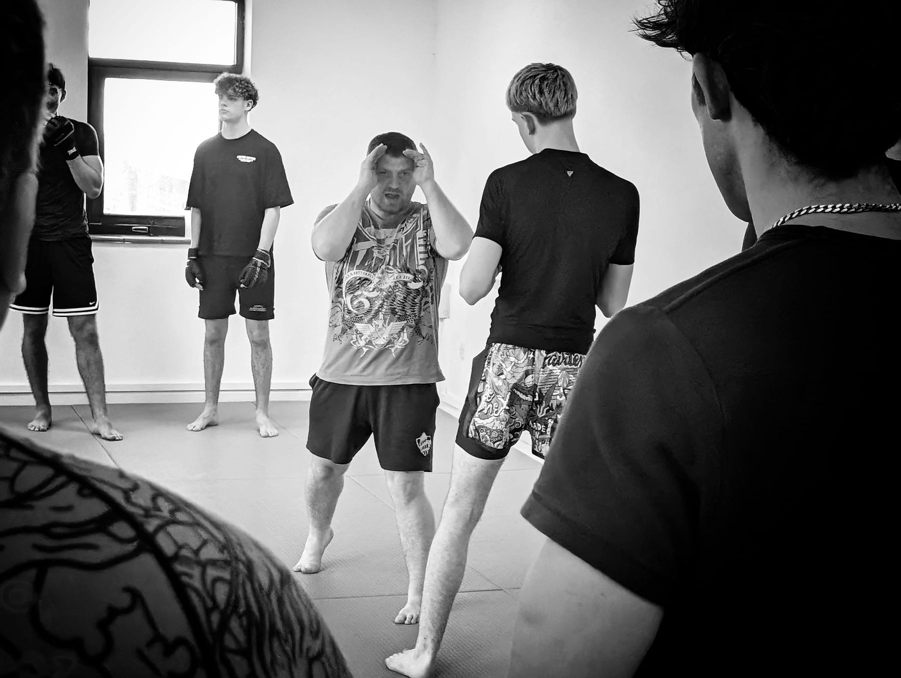 Jordan Squires coaching a class through a striking drill