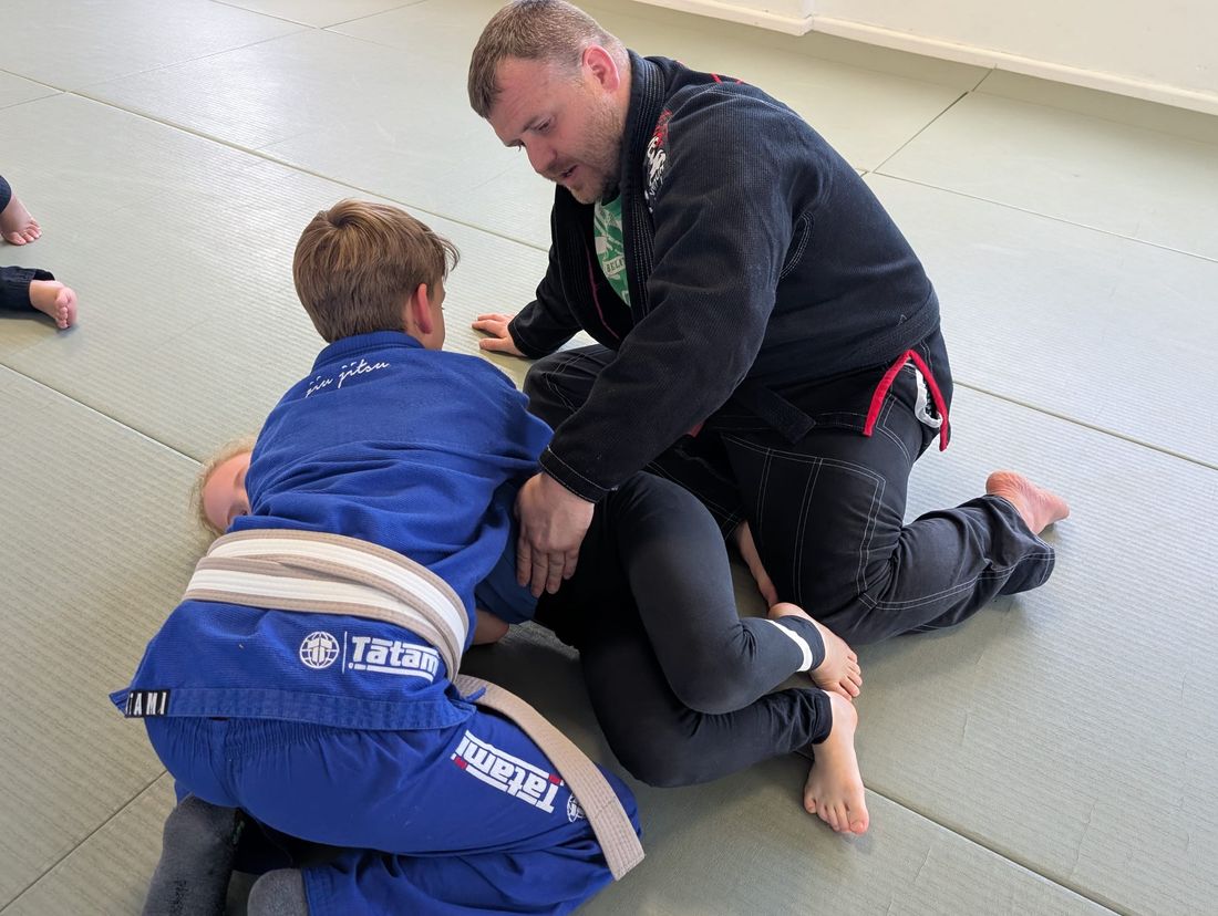 Children practising Jeet Kune Do self-defence techniques with an instructor